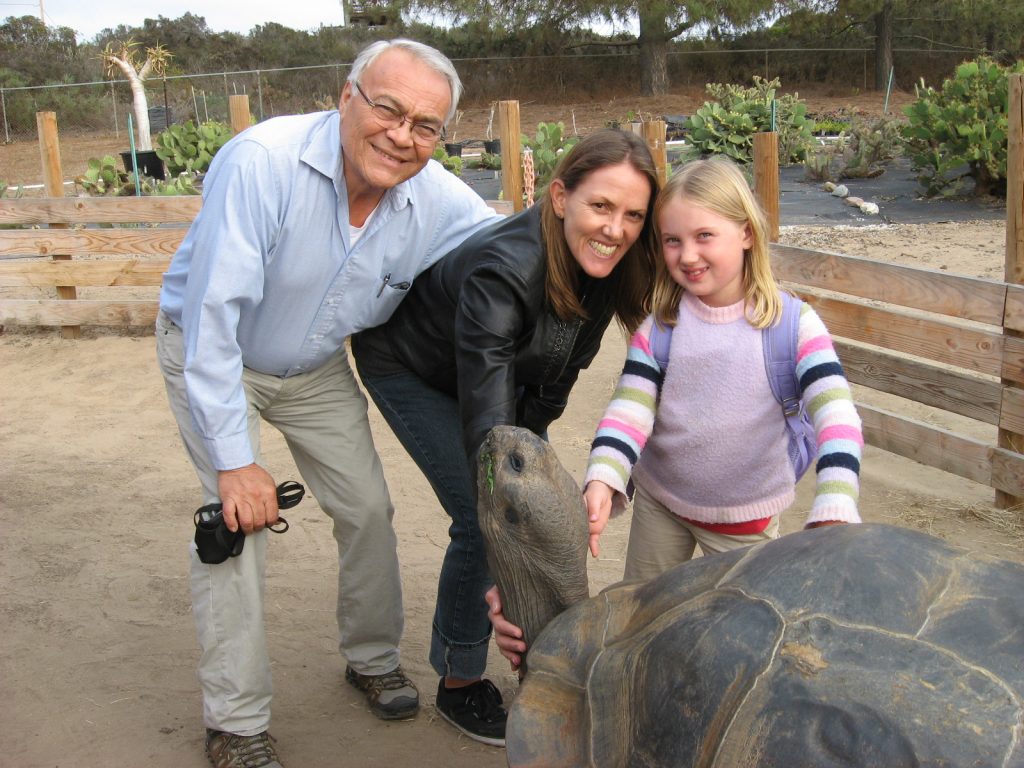 Rafael enjoying some family time while a large tortoise enjoys some fresh veggies. 